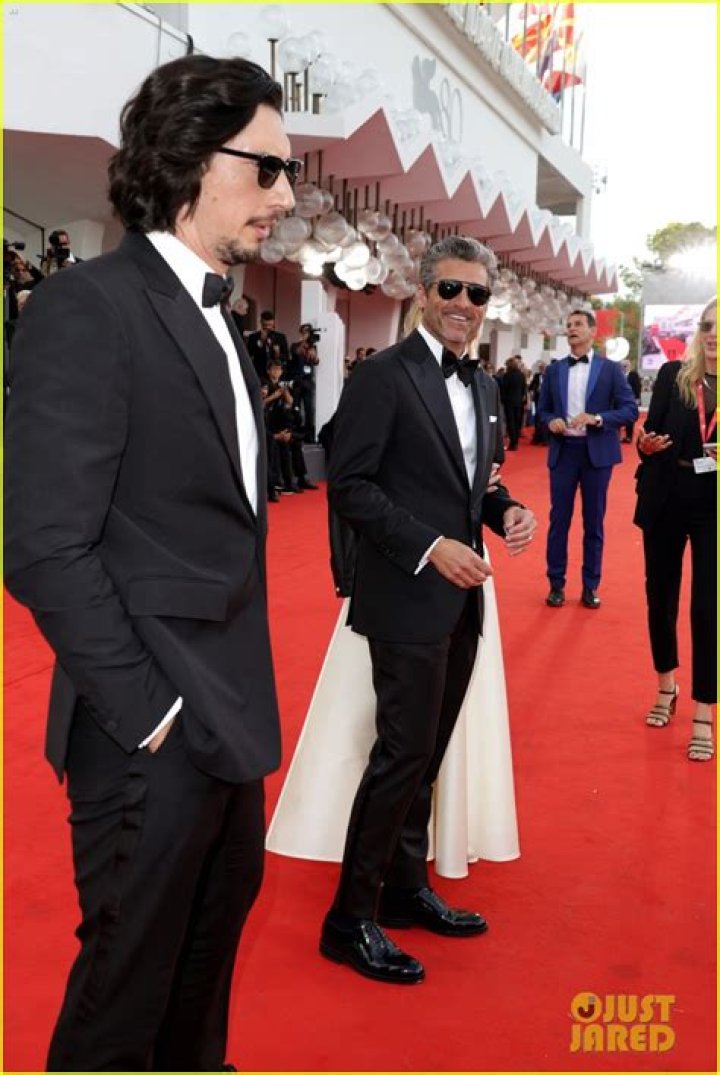 Adam Driver and Patrick Dempsey are standing together on a red carpet.