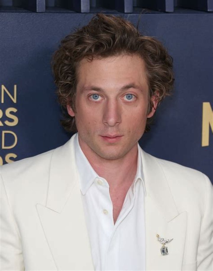 Jeremy Allen White from The Bear is plating a meal in the kitchen.