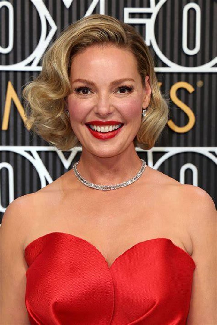 Katherine Heigl is smiling and looking to the side.