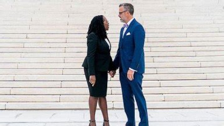 Patrick G. Jackson holding the Bible whiles his wife is sworn in